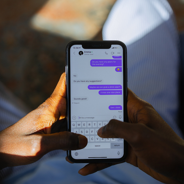 A pair of hands using messenger app, messaging a friend